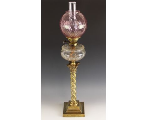 An F S & Co Ltd oil lamp of large proportions, late 19th or early 20th century, the dimpled cranberry glass shade above a cut