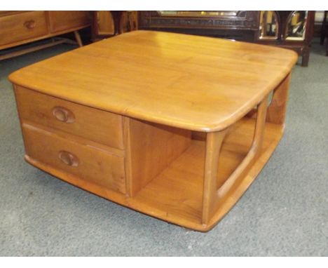 Ercol 'Pandora's Box' coffee table in light elm, with integral cubby holes and two drawers, carried on original castors, heig