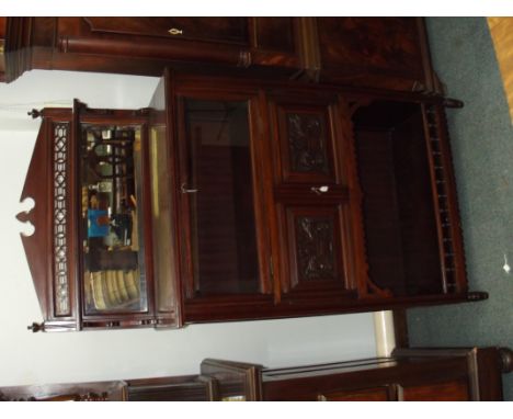 Edwardian music cabinet, broken arch pediment above a raised back with geometric and quatrefoil fretwork inset with bevelled 