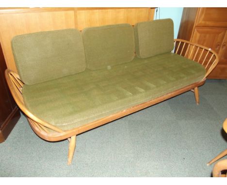 Ercol daybed in light elm, detachable solid plank back above a beech stick frame, carried on splayed supports, height 77cm, w