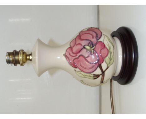 Moorcroft pottery table lamp, baluster form in the Pink Magnolia pattern against an ivory ground, height 25cm