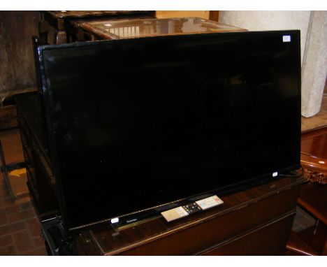 A Toshiba 44 inch flat screen TV - with mounted wall bracket, power cable and remote 