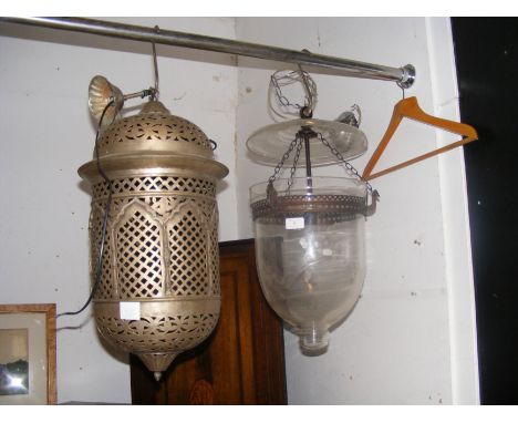 A glass and metal porch light together with one other metal porch light
