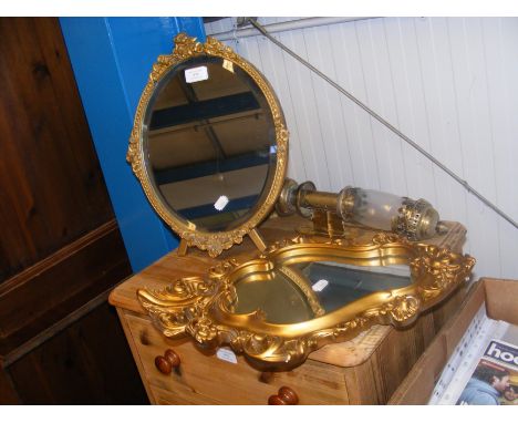 A gilt oval mirror, together with one other mirror and brass wall light 