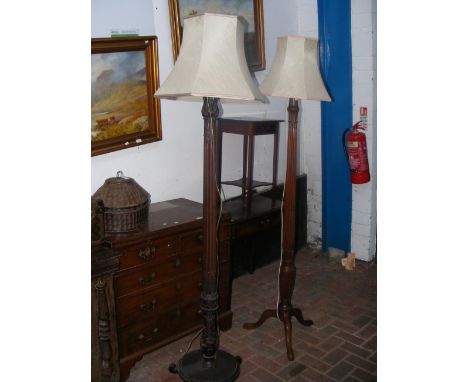 An antique standard lamp together with one other
