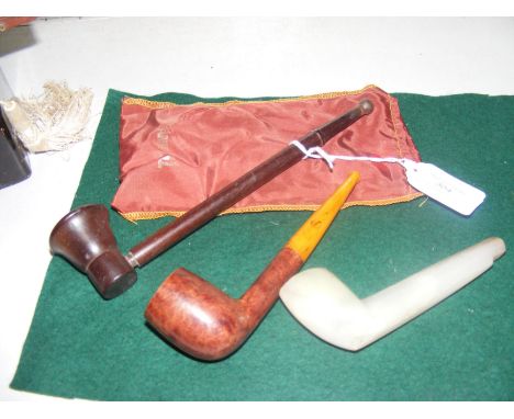 A jade pipe with two other vintage pipes