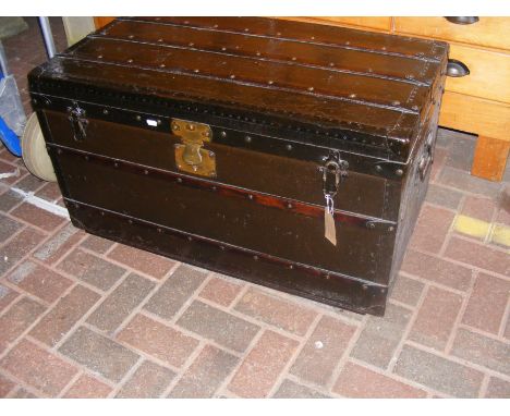 A late 19th century Goyard of Paris travelling trunk, having canvas with ash batons and brass studs - the lock engraved 'E. G