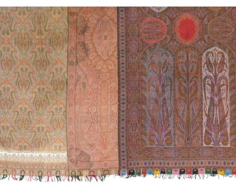 Shawls. A large Paisley shawl, mid 19th century, polychrome woven wool shawl, with central red oval flanked on either side by