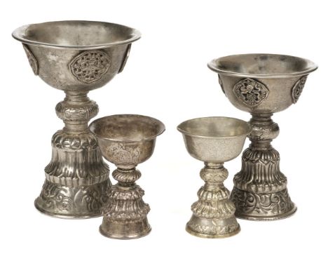 Tibet. An early 20th century Tibetan butter lamp, the silver-plated lamp with everted rim to the bowl on a knopped pedestal w
