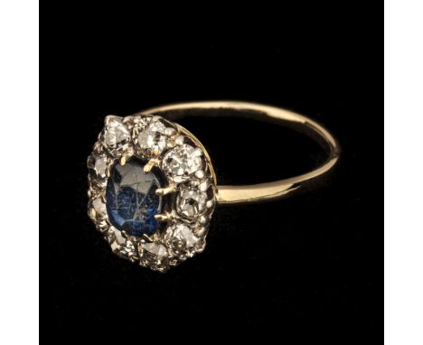 Sapphire &amp; Diamond Ring. A Victorian 14k diamond and sapphire cluster ring, set with a 1.16ct cut sapphire surrounded by 