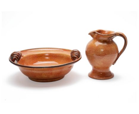 A MOTTLED BURNT ORANGE GLAZED ITALIAN BOWL AND PITCHER
The bowl with curling handles, the pitcher with a twisted handle, by M