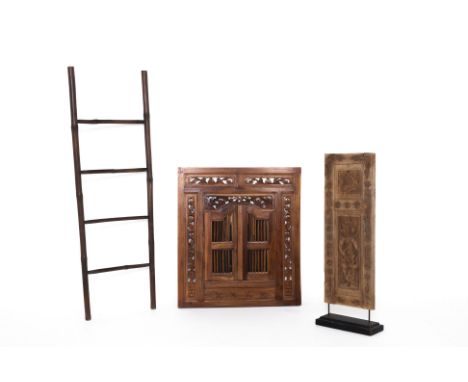 A GROUP OF THREE DECORATIVE OBJECTS
Comprising an Indonesian carved panel on stand, a ladder rack and a carved wood decorativ