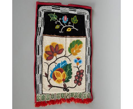 Ojibwe beaded bandolier bag with open sash, black velvet, foliate motifs, and beaded yarn tassels, circa early 20th century. 