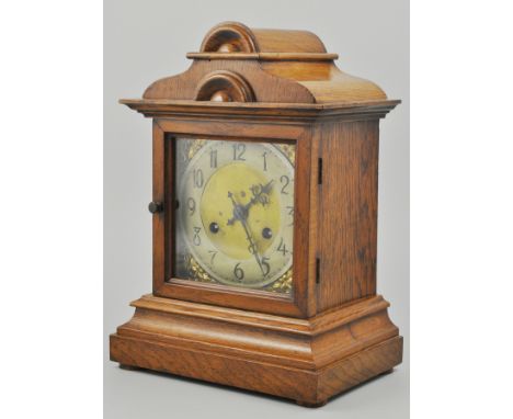 Edwardian oak mantel clock, architectural case, square brass dial with foliate spandrels, German movement, striking on a gong