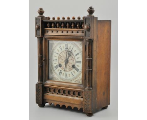 Victorian walnut and stained wood mantel clock, spindle frieze, with pilasters, printed square dial, movement striking on a g