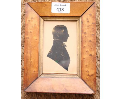 A 19th Century miniature silhouette portrait of a gentleman, highlighted in gilt, 4" x 3", in maple frame