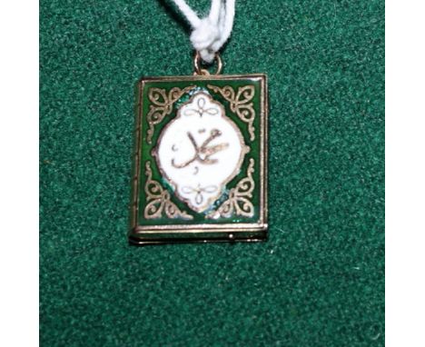 A gold and enamel decorated locket in the form of the Koran