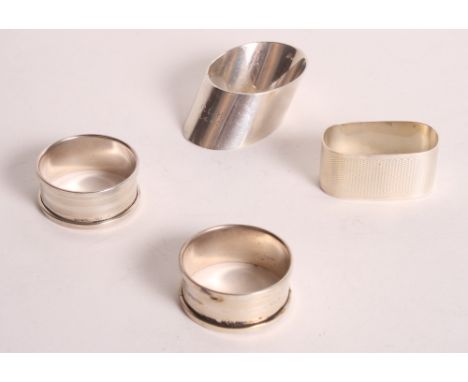 A pair of silver engine turned napkin rings, a silver oval napkin ring and one other silver napkin ring, 2.6oz troy approx