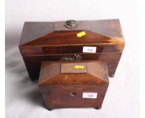 An early 19th Century mahogany sarcophagus-shaped two-compartment tea caddy with central mixing bowl recess, 12" wide, and a 