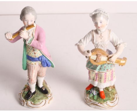 A pair of 19th Century Meissen porcelain figures of a girl playing a hurdy gurdy and a boy playing a flute, 5 1/2" high