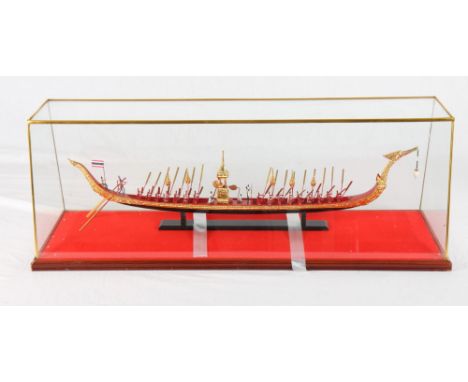 A scale model of the Thai Royal Barge with figures and oarsmen, 23" long, in glass case