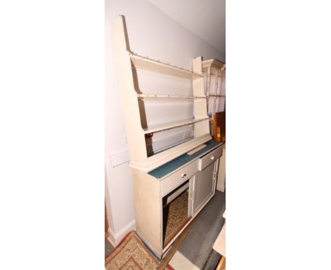 An early 20th century white painted pine dresser, three shelf open back, base fitted two drawers and cupboard enclosed by sli