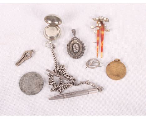 A Victorian silver locket, a silver Albert watch chain, a silver folding button hook, a plated sovereign case, two commemorat