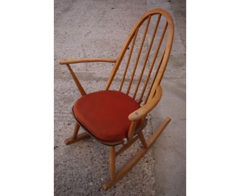 An Ercol high stick back rocking elbow chair