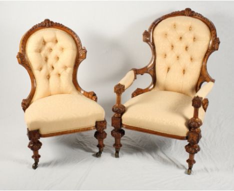 A late 19th Century French walnut framed open armchair, button upholstered in a gold damask, and a matching nursing chair