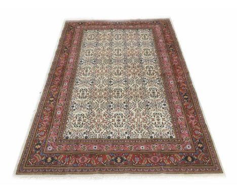 Good Kaysari handmade carpet, with repeated foliate pattern on a natural ground within multiple repeated red borders, 115" x 