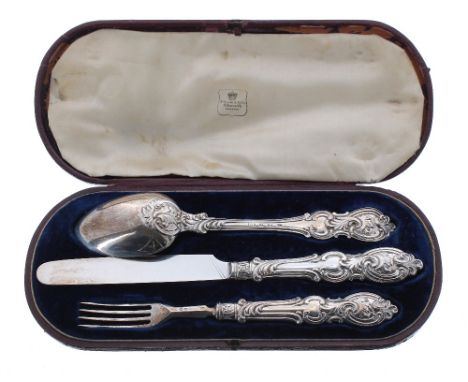 Victorian silver cased christening knife, fork and spoon each with decorative scroll work handle, maker Aaron Hadfield, Sheff