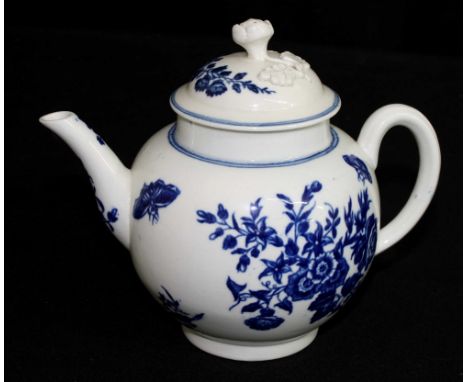 Early Worcester blue and white porcelain teapot, crescent period, decorated with butterflies and flowers, the lid with applie