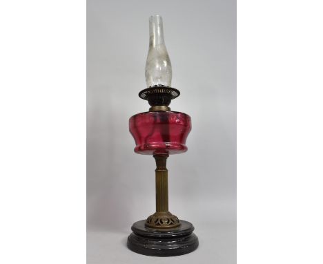 A Late Victorian Brass and Cranberry Glass Oil Lamp with Ribbed Column Support, Dual Controls, Glass Chimney but No Shade, Ov