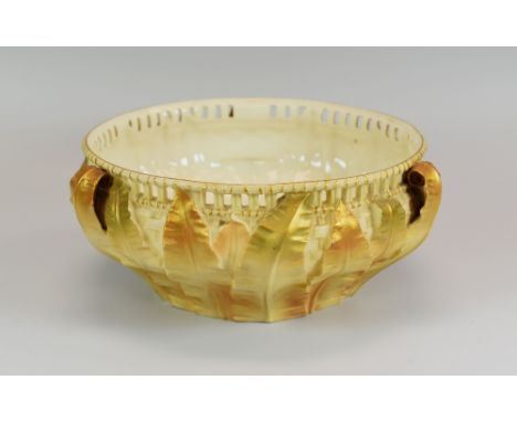 A ROYAL WORCESTER LEAF-FORM BOWL with three handles, basket-weave moulding and having an arcaded rim, with blush ivory glaze,