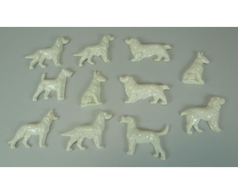 A SET OF ELEVEN CERAMIC DOGS possibly Royal Worcester blanks, each being studies of different breeds & in different poses, mo