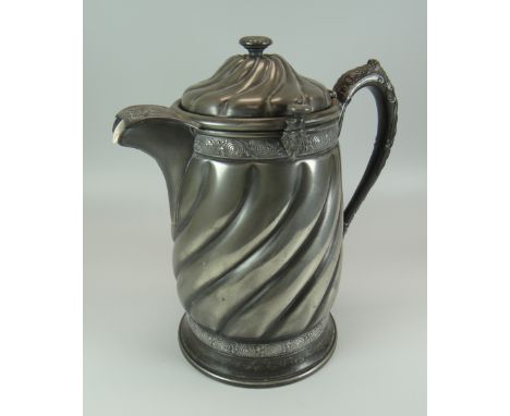 A REED & BARTON WHITE METAL ICE-PITCHER with ceramic liner within the swirl decorated outer, 30cms high Provenance: entered b
