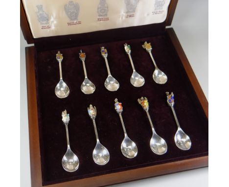 A CASED SET OF TWELVE ELIZABETH II SILVER HERALDIC SPOONS entitled 'The Queen's Beasts Collection' having enamel and figural 