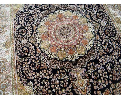 A BLUE GROUND WOVEN SILK CARPET with Shahbaz medallion design, 300 x 198cms