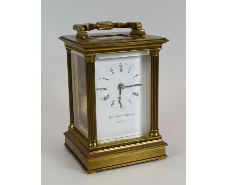 MATTHEW NORMAN OF LONDON CARRIAGE CLOCK the movement Swiss made and having a white enamel dial bearing Roman numerals, serial