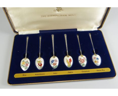 A CASED SET OF ENAMEL SPOONS by the Birmingham Mint, with certificate, each spoon enamelled with botanical specimens, dated 1