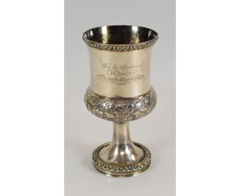 AN INTERESTING SILVER GOBLET of circular footed form with knopped body and funnel top, having raised floral decoration and en