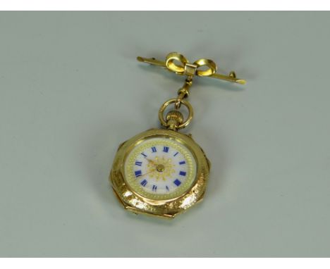 A 15K BRIGHT-CUT YELLOW GOLD OCTAGONAL FOB-WATCH with decorative enamel dial, Swiss made, with attached bow brooch, 25.8gms