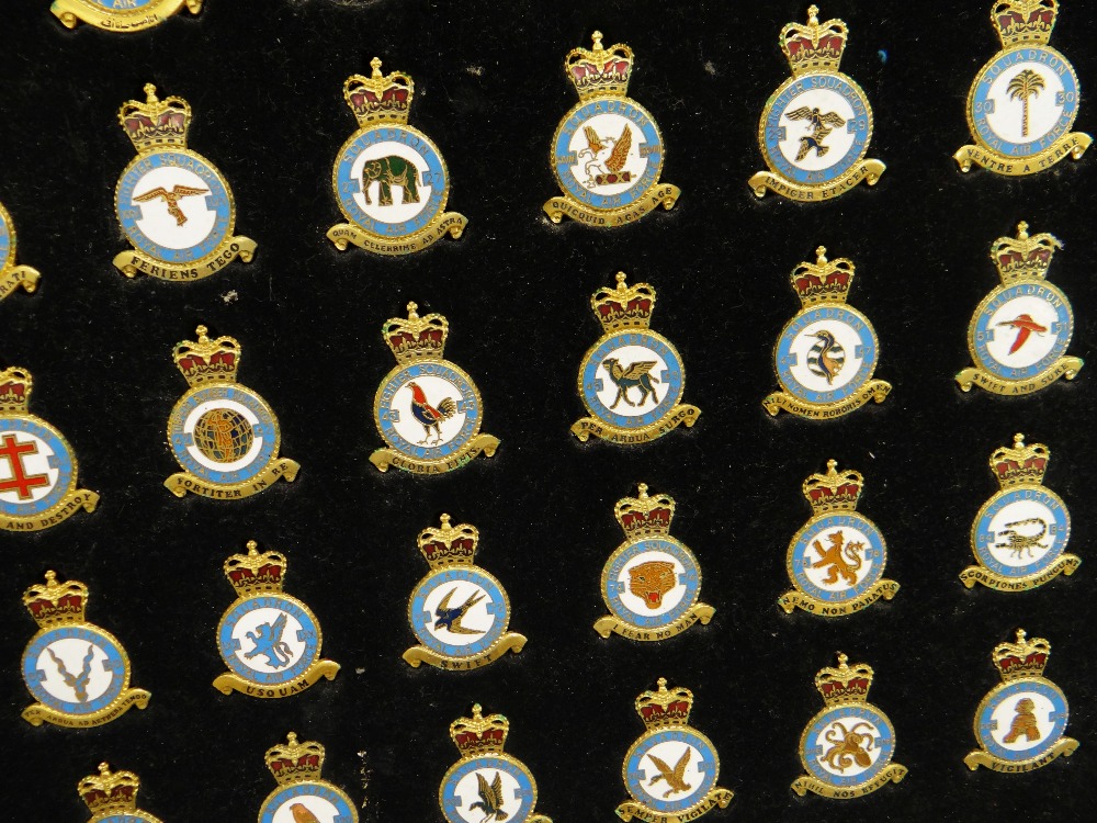 A DISPLAY FRAME OF ENAMELLED RAF SQUADRON BADGES