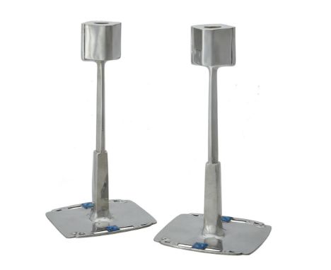 Archibald Knox (1864-1933) for Liberty, Tudric range, a pair of Arts and Crafts pewter and enamel candlesticks, circa 1905, w