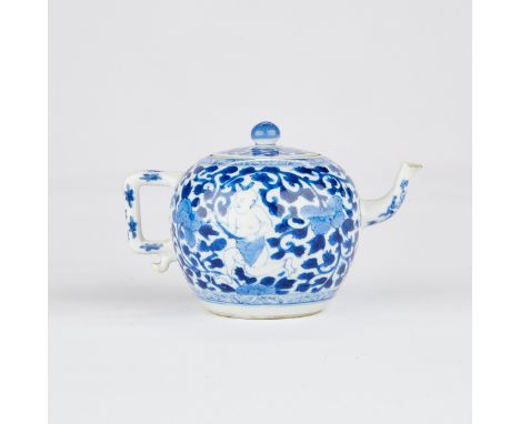 Kangxi period Chinese export porcelain teapot, with blue and white decoration depicting a boy among vines and flowers. Marked