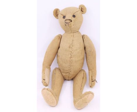 Steiff: An early 20th century humpback Steiff bear, with pointed nose, shoe button eyes, straw filled, with padded paws and f