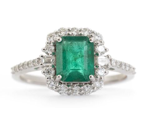 EMERALD AND DIAMOND RING, set with a central step cut emerald within a diamond halo, on diamond shoulders totalling approxima