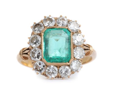 EMERALD AND DIAMOND CLUSTER RING, set with a central octagonal step cut emerald of approximately 2.00 carats, within a halo o