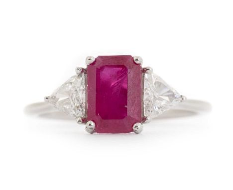RUBY AND DIAMOND THREE STONE RING, set with a central step cut ruby flanked by trillion cut diamonds totalling approximately 