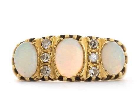 OPAL AND DIAMOND RING, set with three oval opals spaced by six small diamonds, in eighteen carat gold, size RQty: 5.56g